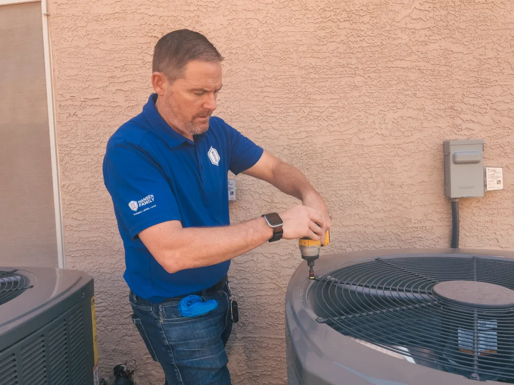 AC tech in Phoenix checking an HVAC unit